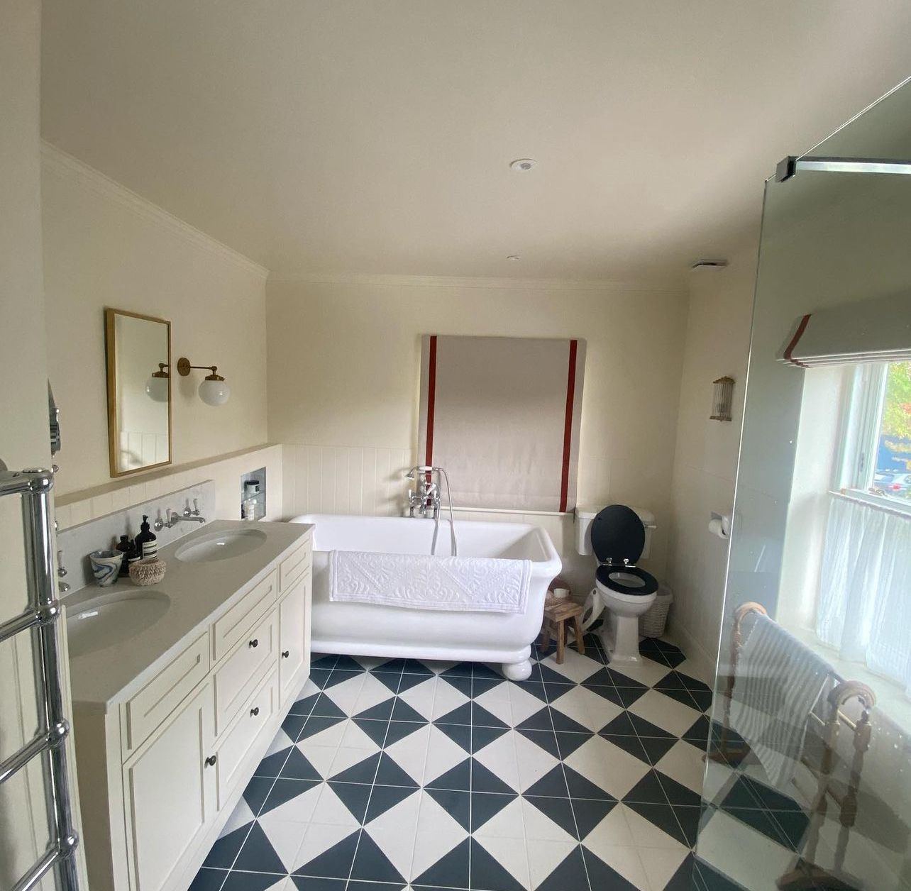 Bathroom with freestanding bath and chequerboard floor